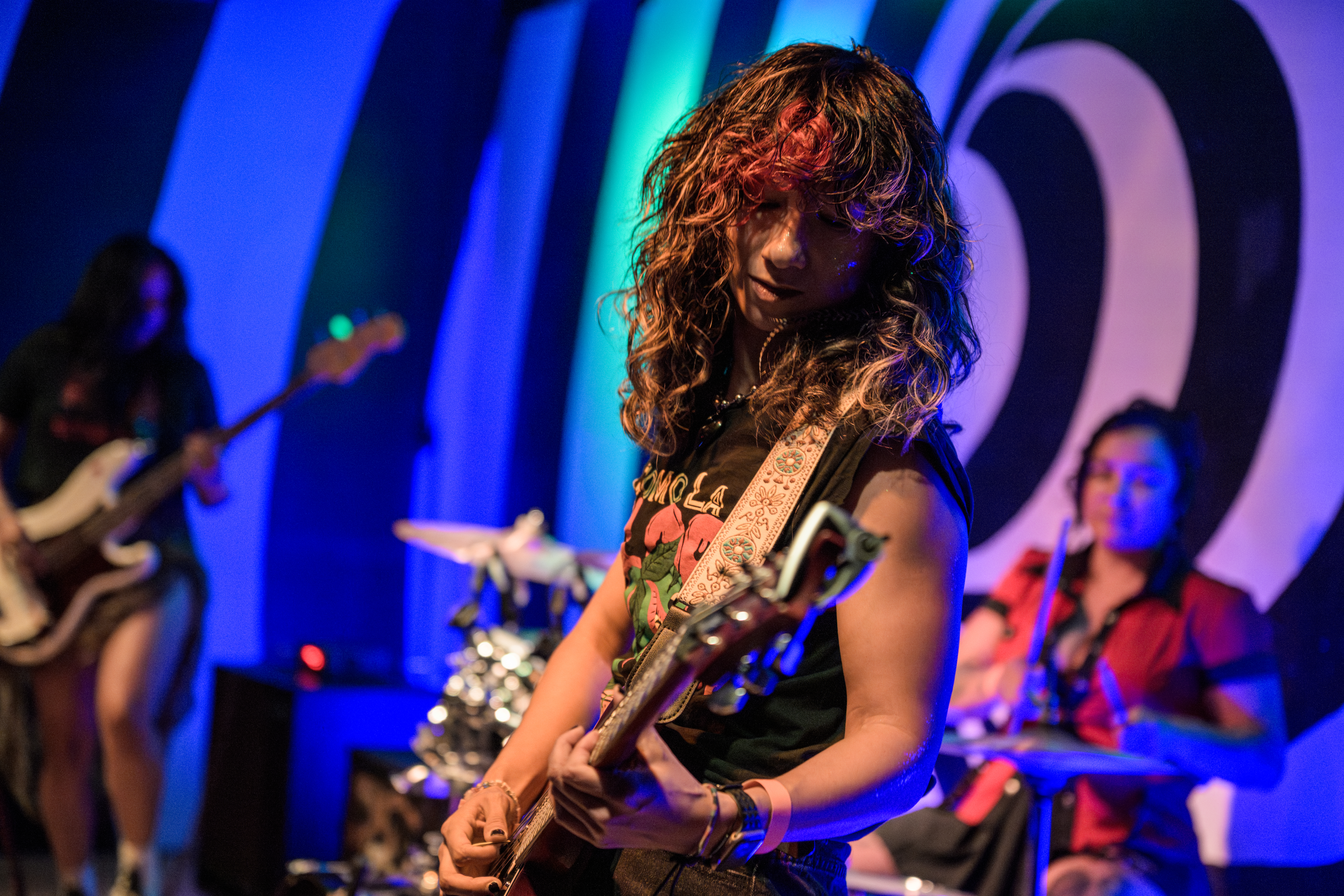 Band performing on stage at Femme Fatale Fest